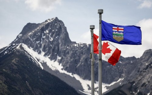 A Canada flag, left, and an Alberta flag flap in the breeze with Wedge Mountain in the background at the site of the G7 Leaders meeting in Kananaskis, Alta., Monday, June 2, 2025.THE CANADIAN PRESS/Jeff McIntosh