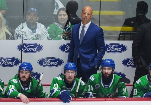 Abbotsford Canucks' head coach Manny Malhotra stands on the bench behind Sammy Blais, front left to right, Jonathan Lekkerimaki and Phillip Di Giuseppe during the first period in Game 5 of the AHL Calder Cup Final against the Charlotte Checkers, in Abbotsford, B.C., on Saturday, June 21, 2025. THE CANADIAN PRESS/Darryl Dyck