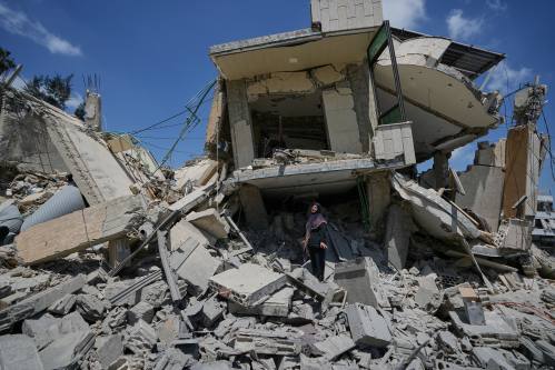 Hanan Qubaisi inspects her house destroyed in previous Israeli airstrikes in the town of Nabatiyeh, southern Lebanon, on Wednesday, after a ceasefire between Israel and Hezbollah. (The Associated Press)