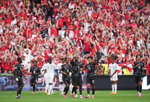 Canada's Nathan Saliba (25) celebrates his goal against Qatar with Cyle Larin (9) and Ali Ahmed (20) during the second half of a World Cup Group B soccer match, in Vancouver, on Thursday, June 18, 2026. THE CANADIAN PRESS/Darryl Dyck