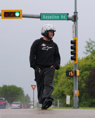 Caden Skelton crosses the intersection of Sherwood Dr. and Baseline Rd. in Sherwood Park, Alta., on Saturday, June 20, 2026. THE CANADIAN PRESS/James Maclennan
