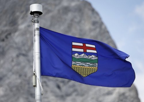 An Alberta flag flaps in the breeze with Mt. Kidd in the background at the site of the G7 Leaders meeting in Kananaskis, Alta., on Monday, June 2, 2025. THE CANADIAN PRESS/Jeff McIntosh