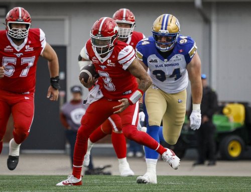 Winnipeg Blue Bombers' Jake Ceresna, right, looks on as Calgary Stampeders quarterback Vernon Adams Jr. runs the football during first half CFL football action in Calgary, Friday, June 5, 2026.THE CANADIAN PRESS/Jeff McIntosh