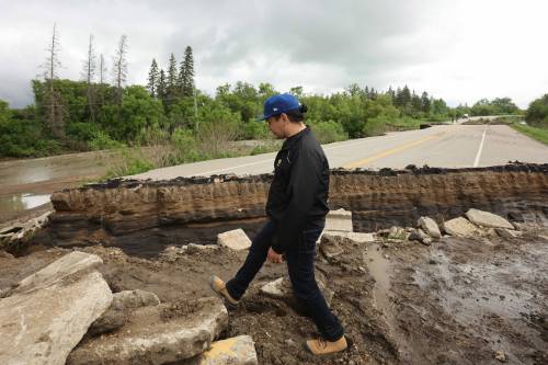 Manitoba Premier Wab Kinew tours damage to Highway 10 at Tamarack Creek just east of Swan River on Wednesday after intense rainfall caused the river to swell and damaged the highway. Despite his good intentions, those whose homes were damaged by recent flooding should be wary whether the premier and his government can afford to make good on his commitments for financial support. (Tim Smith/The Brandon Sun files)