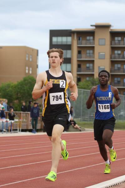 Nellie McClung's Soren Reid, left, pulled away from St. Maurice's John Adeloye during the 800-metre race of the varsity boys' pentathlon, overtaking the Patriot for first place at high school track and field provincials in Winnipeg on Friday. (Thomas Friesen/The Brandon Sun)