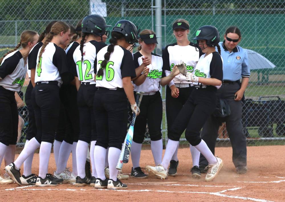 Rooney Laluk of the Eastman Selects is greeted at home by her teammates after her leadoff home run gave the Selects a 1-0 lead over the Westman Magic in the first inning of the Wheat City Classic's under-15 gold medal game at the Ashley Neufeld Softball Complex on Sunday. Eastman won 6-1. (Perry Bergson/The Brandon Sun) June 14, 2026