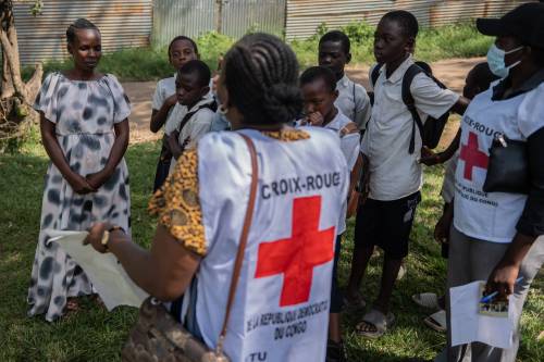 Vanny Birungi, a Red Cross volunteer, speaks to people during a house-to-house sensitization campaign amid the Ebola outbreak in Bunia, Congo, last month. (The Associated Press files)