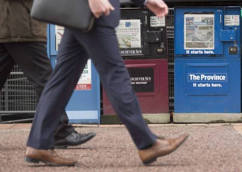A man walks past newspaper boxes in downtown Vancouver in January 2016. On the list of countries with smart news media policies, Canada is right up there at the top, Stig Ørskov writes. (The Canadian Press files)