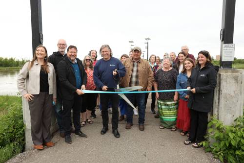 Brandon Mayor Jeff Fawcett prepares to cut a ribbon while surrounded by other dignitaries during an event at the Riverbank Discovery Centre on Monday morning to announce the adding of five city-owned lands to Manitoba’s Protected and Conserved Areas Network. (Tim Smith/The Brandon Sun)