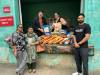 Murray Kempthorne (top left) and Angie Hartley of Helping Hands join Sikh Centre representatives Narinderpal Brar (left standing), Kulwinder Bathh and Jobanpreet Singh in a picture with the essential food items donated by the group last week. (Submitted)