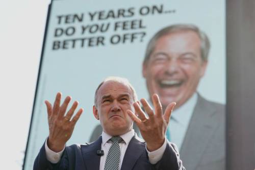 Liberal Democrat Leader Ed Davey speaks in front of a billboard showing Reform UK Leader Nigel Farage as he unveils a new national billboard campaign to mark the 10th anniversary of the Brexit referendum in London on Tuesday. Chris Smith writes that a decade after the Brexit vote, &ldquo;Leave and Remain still provide the most comprehensive fault line across the U.K. in 2026.&rdquo; (The Associated Press)