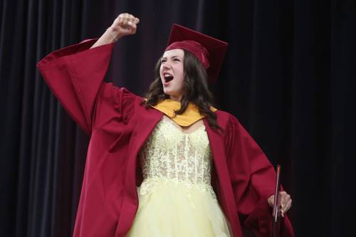 Graduate Eliza Taggart pumps her fist in celebration while receiving her diploma during the Crocus Plains Regional Secondary School 2026 graduation ceremony at Assiniboine Credit Union Place on Tuesday. (Photos by Tim Smith/The Brandon Sun)