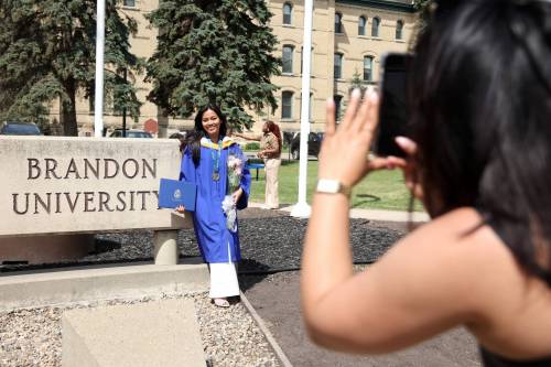 Divina Suazo has photos taken in front of the Brandon University sign along 18th Street in front of Clark Hall after receiving her bachelor of nursing degree during BU&rsquo;s convocation last month. Ali Jasemi writes that people can often believe they&rsquo;ve fallen behind the pace set by others because they&rsquo;re bombarded by &ldquo;a curated, global, endless social media highlight reel: the cousin&rsquo;s engagement, the classmate&rsquo;s promotion, the stranger&rsquo;s home tour.&rdquo; (Tim Smith/The Brandon Sun)