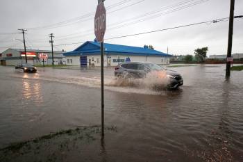 A small sea of rainwater greets motorists at the corner of 16th Street and Park Avenue late Monday afternoon in the middle of a rainstorm that flooded streets and intersections in many parts of the city. (Matt Goerzen/The Brandon Sun)
                                A small sea of rainwater greets motorists at the corner of 16th Street and Park Avenue on Monday afternoon in the middle of a rainstorm that flooded streets and intersections in many parts of the city. (Matt Goerzen/The Brandon Sun)