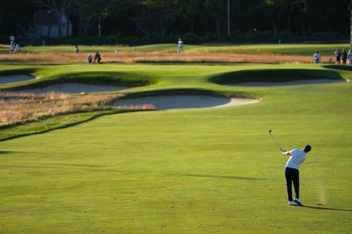 Wyndham Clark hits from the fairway on the 15th hole during the third round of the U.S. Open golf tournament at Shinnecock Hills Golf Club in Southampton, N.Y., Saturday, June 20, 2026. (AP Photo/George Walker IV)
