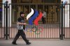 A man walks past a fence with Olympic Rings in front of the Russian National Olympic Committee building in Moscow, on Tuesday, July 7, 2026. (AP Photo/Pavel Bednyakov)