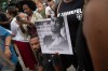 FILE - A person holds up a photo of O'Shae Sibley during a vigil at a gas station, Aug. 4, 2023, in the Brooklyn borough of New York. (AP Photo/Tracie Van Auken, File)
