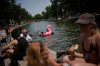 Parisians bath in the Canal Saint-Martin in Paris, as the national weather service, Meteo France, placed 54 departments, about half the country, under a red heat wave alert, Tuesday, June 23, 2026. (AP Photo/Christophe Ena )