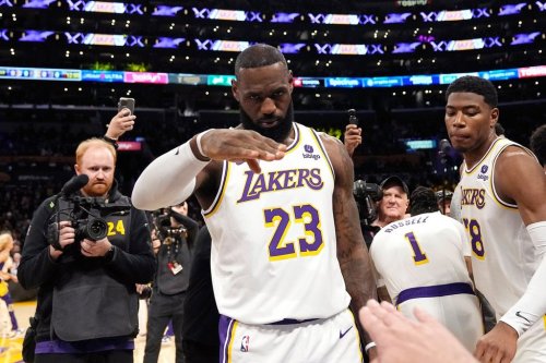 FILE - Los Angeles Lakers forward LeBron James salutes public address announcer Lawrence Tanter prior to an NBA basketball game against the Denver Nuggets Saturday, March 2, 2024, in Los Angeles. (AP Photo/Mark J. Terrill,File)
