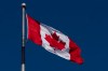The Canadian flag is seen flying behind the National Archives building in Ottawa Friday, Feb. 14, 2025 in Ottawa.   THE CANADIAN PRESS/Adrian Wyld