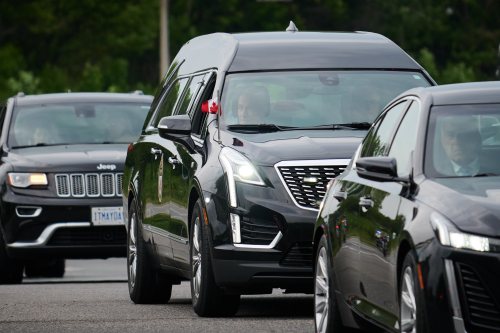 A police escort leads a procession with the body of Toronto Police Const. Marc Pinizzotto, who was killed in the line of duty conducting a raid earlier in the day, at the Chief Coroner's office, in Toronto, on Thursday, June 11, 2026. THE CANADIAN PRESS/Sammy Kogan