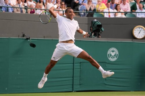 Felix Auger-Aliassime of Canada jumps to play a return during the men's singles fourth round match against Alejandro Davidovich Fokina of Spain at the Wimbledon Tennis Championships in London, Sunday, July 5, 2026.(AP Photo/Kin Cheung)