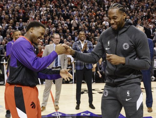Former Toronto Raptors and now LA Clippers forward Kawhi Leonard, right, receives his 2019 NBA championship ring from Raptors' Kyle Lowry prior to NBA basketball action in Toronto on Wednesday, December 11, 2019. THE CANADIAN PRESS/Nathan Denette