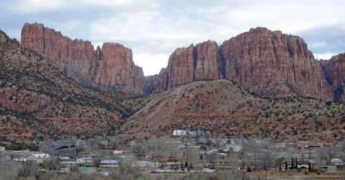FILE - Hildale, Utah, sits at the base of Red Rock Cliff mountains, with its sister city, Colorado City, Ariz., in the foreground, on Dec. 16, 2014. (AP Photo/Rick Bowmer, File)