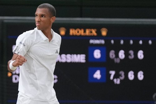 Felix Auger-Aliassime of Canada celebrates winning the fourth set against Novak Djokovic of Serbia in their quarterfinal men's singles match at the Wimbledon Tennis Championships in London, Tuesday, July 7, 2026. (AP Photo/Maja Smiejkowska)