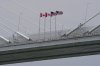 Canadian and American flags fly in the breeze on the Gordie Howe Bridge under construction between Windsor, Ont., and Detroit on May 22, 2026. (AP Photo/Paul Sancya, File)