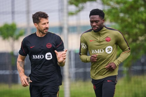 Canada's Alphonso Davies, right, runs laps during a Team Canada World Cup training session in Toronto, on Wednesday, June 10, 2026. THE CANADIAN PRESS/Sammy Kogan
