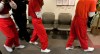 The Federal Court has granted Ottawa a judicial review of a decision by the Immigration and Refugee Board of Canada ordering the release of an alleged member of an India-based criminal gang who has been detained since April 2. 
A private security guard escorts Sri Lankan migrants from a detention hearing at the Immigration and Refugee Board in Vancouver, B.C., on Monday October 26, 2009. Seventy-six men were detained when the ship they were aboard entered Canadian waters on October 17. THE CANADIAN PRESS/Darryl Dyck