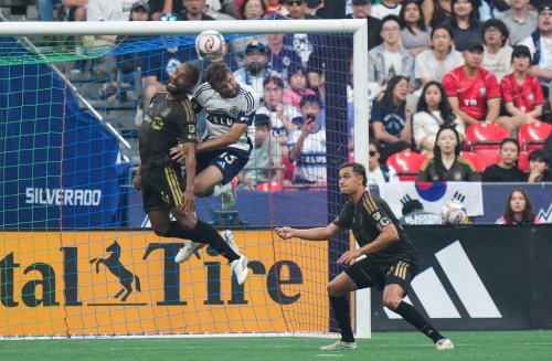 Vancouver Whitecaps' Thomas Muller (13) and Los Angeles FC's Eddie Segura (4) vie for the ball as Aaron Long (33) watches during the first half of an MLS soccer match, in Vancouver, on Saturday, Aug. 1, 2026. THE CANADIAN PRESS/Darryl Dyck