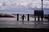 Josiah Carpenter, 8, frolics in the floodwaters on Lakeshore Drive along Lake Pontchartrain as Tropical Storm Bertha approaches the Louisiana Coast Wednesday, July 22, 2026, in New Orleans. (AP Photo/Gerald Herbert)