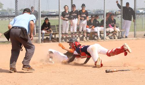 Brandon Marlins base runner Seth Sulik (50) slides across the plate safely as South Central Koen Bleznuk (22) desperately lunges back to tag him under the watchful eye of umpire Bob Blad during the 15-and-under gold medal game at the Triple Crown Showdown at Simplot Millennium Park in 2023. Brandon lost 15-3. The event has set a new record for the number of teams entered over two weekends. (Perry Bergson/The Brandon Sun)