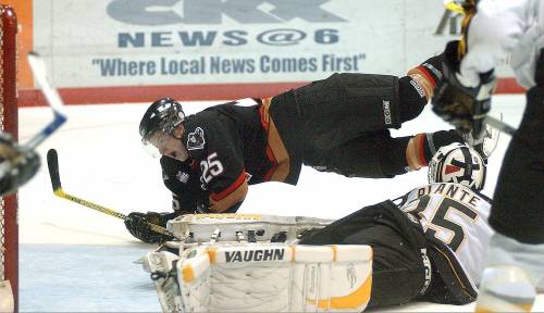 Calgary Hitmen forward Ryan White celebrates as he hits the ice after scoring on Brandon Wheat Kings goaltender Tyler Plante in the final minute of the third period of Game 5 of the Western Hockey League Eastern Conference semifinals in Brandon on April 15, 2005. The two will now work together on the Wheat Kings staff. (Brandon Sun file photo)