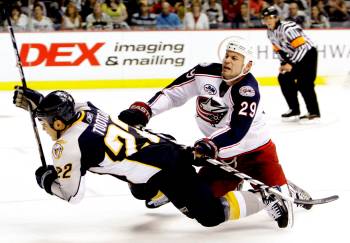 Columbus Blue Jackets defenceman Aaron Rome (29) checks Nashville Predators right wing Jordin Tootoo (22) in the third period of a preseason NHL hockey game in Nashville, Tenn., on Sept. 27, 2008. Both have ties to the Wheat Kings, with Rome serving as an assistant coach and Tootoo playing in Brandon for four years. (Associated Press)