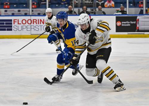 Brandon Wheat Kings defenceman Gio Pantelas (84) and Saskatoon Blades forward Cooper Williams (16) battle for the puck during Western Hockey League action at SaskTel Centre on March 18, 2026. Pantelas will be plying his trade for the Penticton Vees next season but treasures his time in Brandon. (Rick Elvin/Saskatoon Blades)
