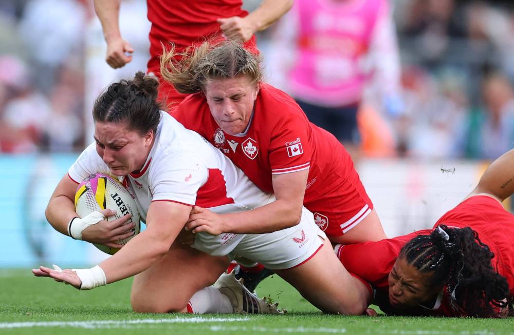 In the final of the Women's World Cup 2025 at Allianz Stadium in London, England on Sept. 27, 2025, Canada's Emily Tuttosi tackles England's Amy Cokayne as Asia Hogan-Rochester falls in the lower right corner. England won 33-13. (Reuters)