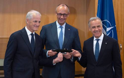 Prime Minister Mark Carney (right), German Chancellor Friedrich Merz (centre) and Norwegian Prime Minister Jonas Gahr Store hold a small model of a TKMS submarine before meeting in Ankara, Turkey, on July 7. (The Canadian Press files)