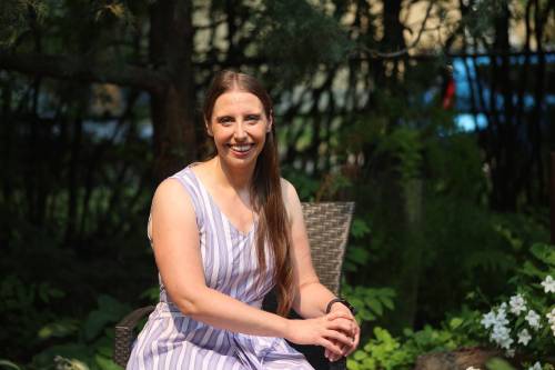 Brandon University co-operative education program co-ordinator Cora Dupuis sits in the historic Moreland Manor garden on Sunday afternoon. Dupuis, who has led the program for seven years, seeks to become the Manitoba NDP candidate for Brandon West. (Abiola Odutola/The Brandon Sun)