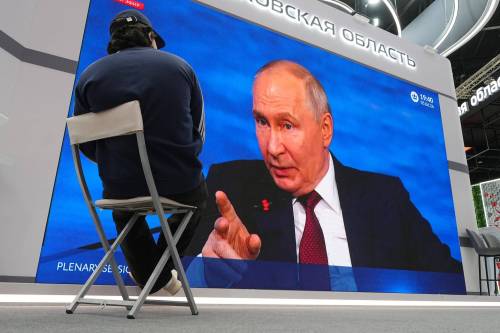 A participant watches a broadcast of Russian President Vladimir Putin&rsquo;s speech on a TV screen during a plenary session of the St. Petersburg International Economic Forum in St. Petersburg, Russia, in June. (The Associated Press files)