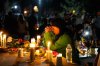 A woman prays during a candlelight vigil Tuesday, Aug. 4, 2026, in Twin Falls, Idaho, to honor the victims of a recent shooting at a local In-N-Out Burger. (AP Photo/Andrew Eakin)