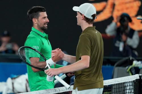 Novak Djokovic, left, of Serbia is congratulated by Jannik Sinner of Italy following their semifinal match at the Australian Open tennis championship in Melbourne, Australia, early Saturday, Jan. 31, 2026. (AP Photo/Asanka Brendon Ratnayake)