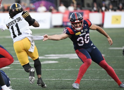 Hamilton Tiger-Cats' Isaiah Wooden Sr., (11) gets by Montreal Alouettes' Joseph Zema (36) to score a punt return touchdown during first half CFL football action in Montreal, on Sunday, July 26, 2026. THE CANADIAN PRESS/Graham Hughes