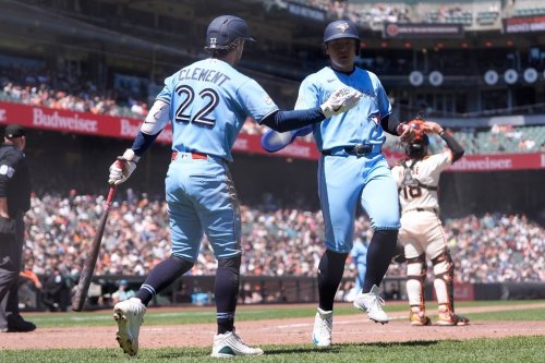 Toronto Blue Jays' Kazuma Okamoto, right, is congratulated by Ernie Clement (22) after scoring against the San Francisco Giants during the eighth inning of a baseball game Wednesday, July 8, 2026, in San Francisco. (AP Photo/Jeff Chiu)
