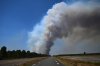 Smoke rises above a road near Saint-Jean-d'Illac, during wildfires in southwestern France, Tuesday, July 28, 2026. (AP Photo/Emma Da Silva)