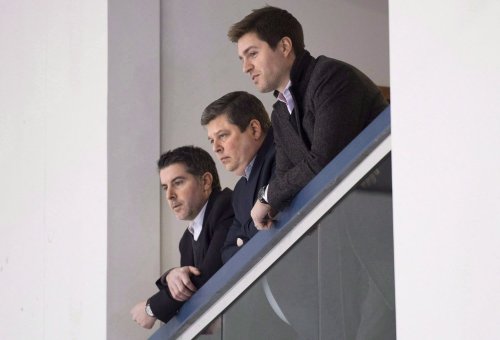 Dave Nonis, centre, senior vice-president and GM of the Toronto Maple Leafs, watches a team practice with Brandon Pridham (left) and Kyle Dubas following the firing of head coach Randy Carlyle in Toronto on Tuesday, January 6, 2015. THE CANADIAN PRESS/Darren Calabrese