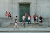 People walk past Bank of Canada security officers striking outside the Bank of Canada headquarters in Ottawa on Monday, June 29, 2026. THE CANADIAN PRESS/Adrian Wyld