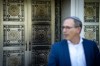 Rabbi Andrew Rosenblatt speaks to media in front of a metal plated door at the Schara Tzedeck synagogue, which was left blackened, in Vancouver, B.C., Friday, May. 31, 2024. THE CANADIAN PRESS/Ethan Cairns
